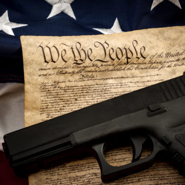 American constitution, USA flag and a handgun